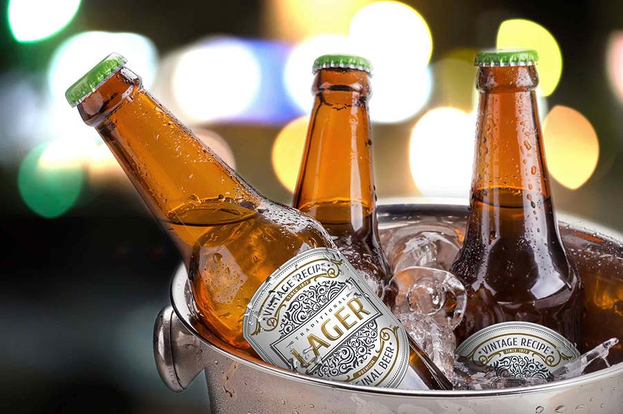 An image of beer bottles in a bucket of ice.