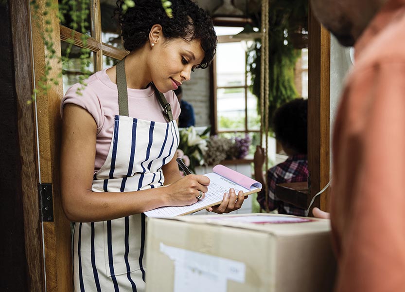 woman writing receipt