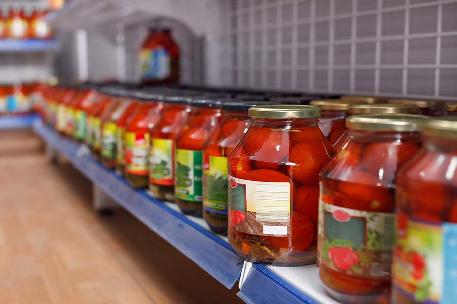 A row of jarred tomatoes on a store shelf