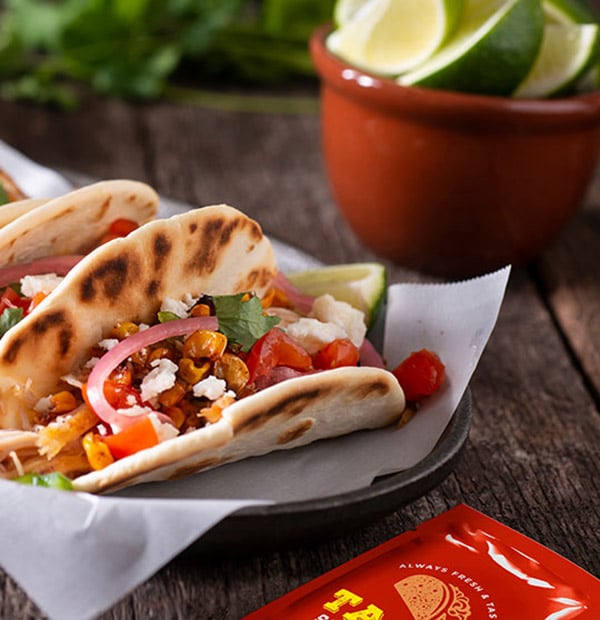 Tacos in tray with laminated paper