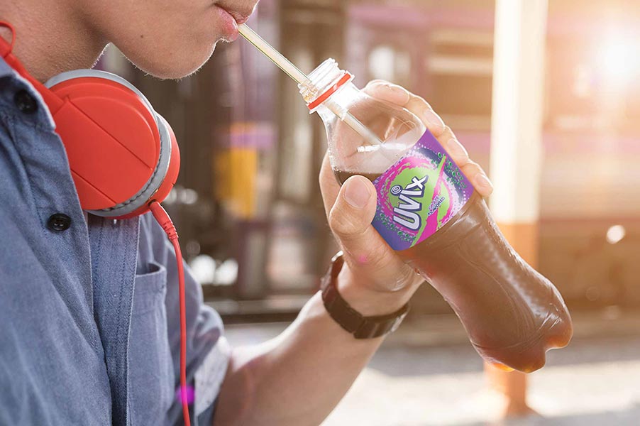 An image of a person drinking soda through a straw.