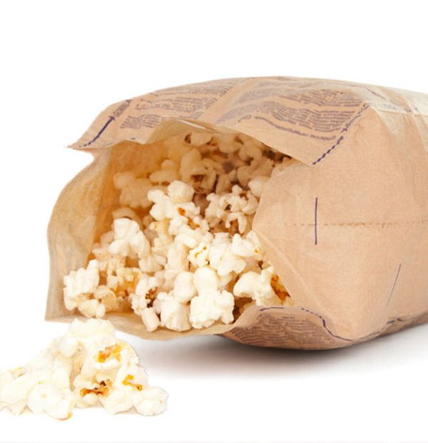 An open bag of microwaveable popcorn