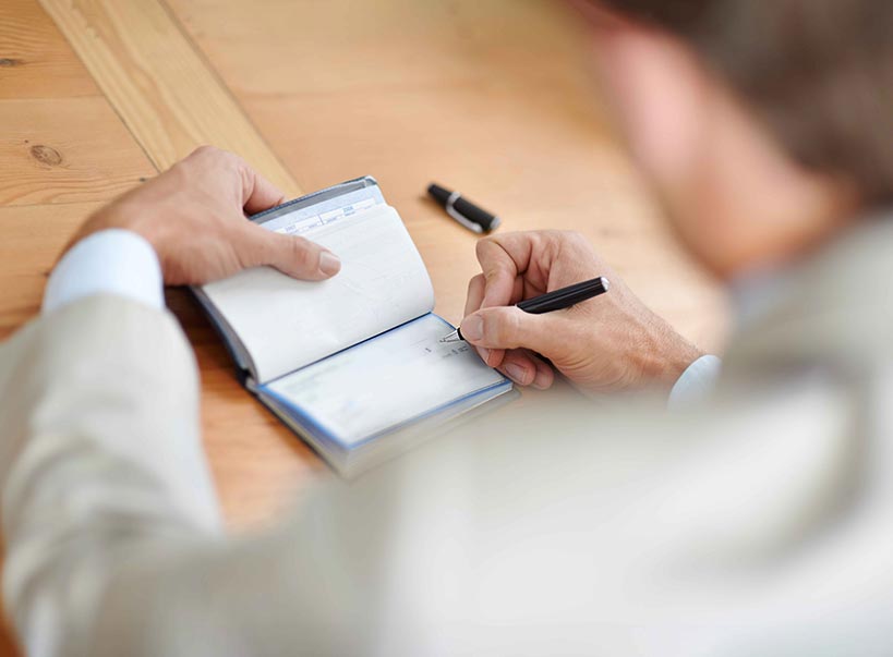 An image of a woman reading a credit card statement.