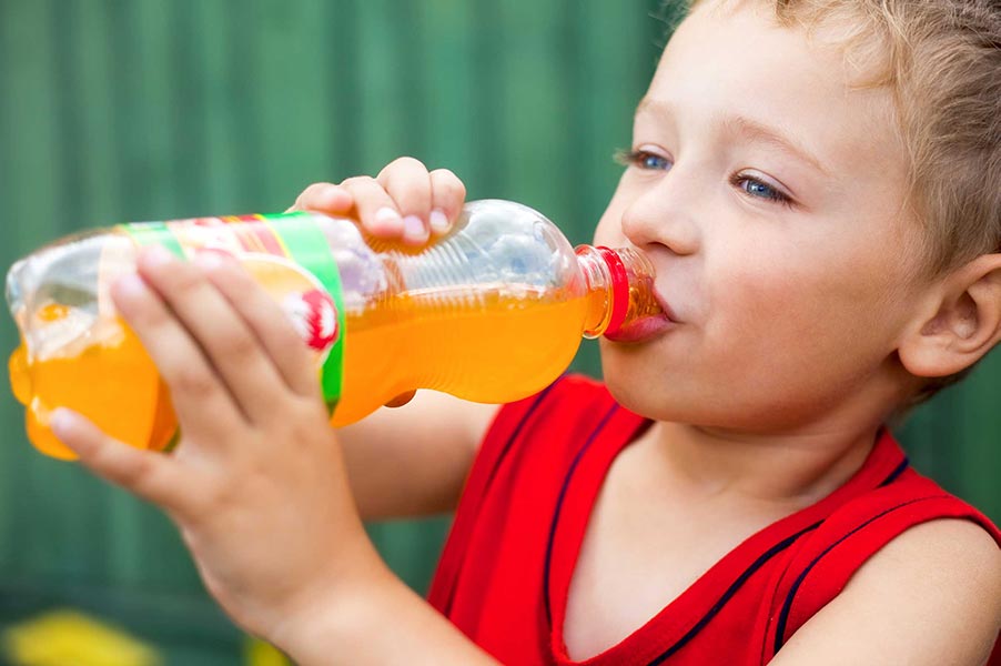 An image of a child drinking out of a bottle.