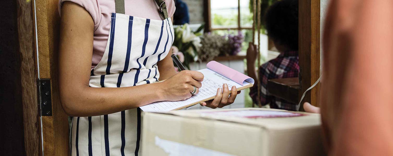 Woman writing a business receipt